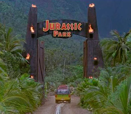 Varios todoterrenos entrando por la puerta principal de la atraccion de Jurassic Park