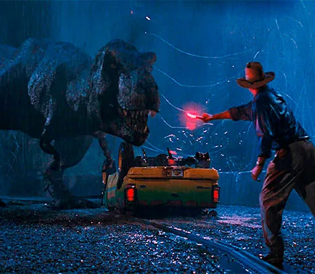 Alan Grant intentando atraer la atención de un Tiranosaurio Rex